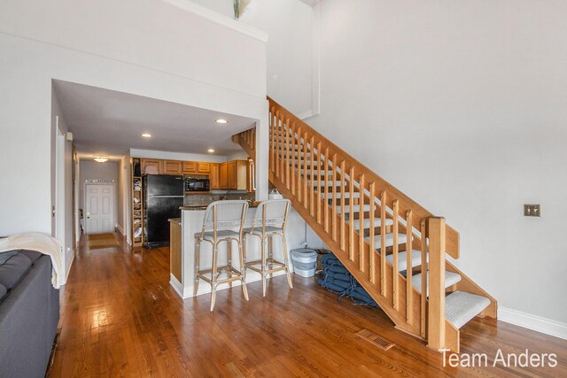 stairs with hardwood / wood-style flooring