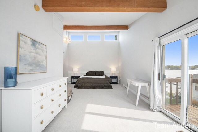 carpeted bedroom with multiple windows, beamed ceiling, and access to exterior