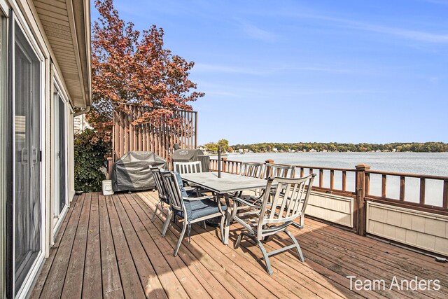 deck featuring grilling area and a water view