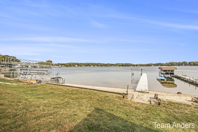 view of dock featuring a yard and a water view