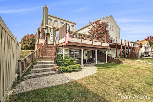 rear view of property with a lawn and a wooden deck