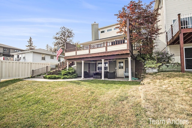 back of house with outdoor lounge area, a yard, a patio area, and a wooden deck