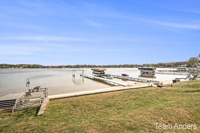 dock area with a water view and a lawn