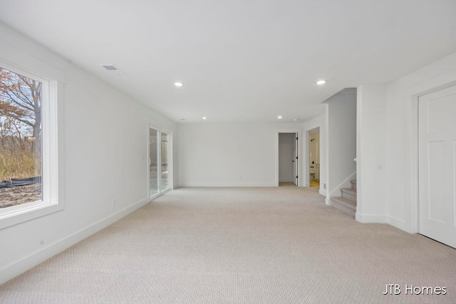 unfurnished room featuring light carpet