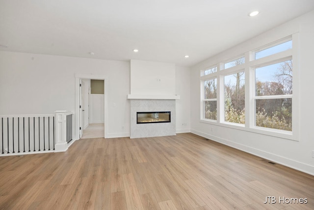 unfurnished living room featuring light hardwood / wood-style flooring