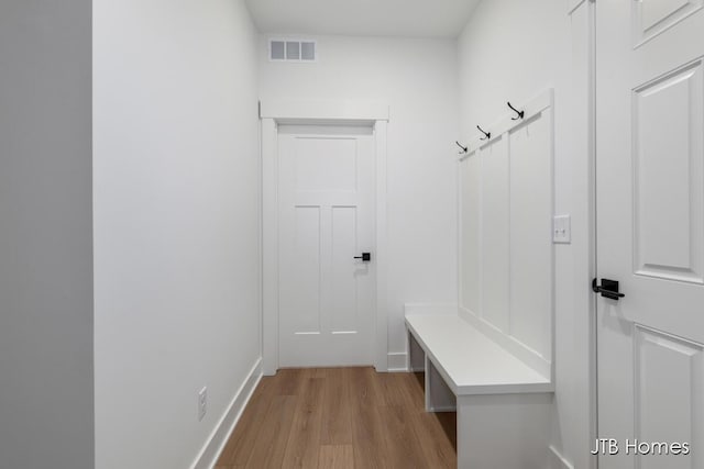 mudroom with light hardwood / wood-style flooring