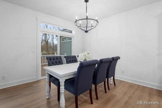 dining room featuring hardwood / wood-style floors and a notable chandelier