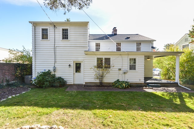 rear view of house with a yard and central air condition unit