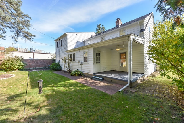 back of property featuring a yard, ceiling fan, and a patio area