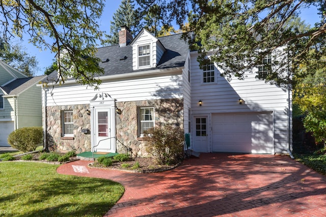 view of front of home with a front yard and a garage