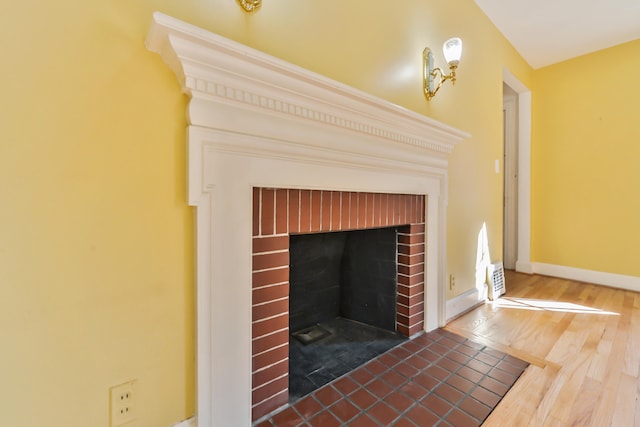 room details with wood-type flooring and a fireplace