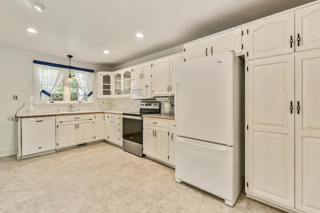 kitchen with white cabinetry, sink, pendant lighting, and white appliances