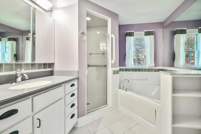 bathroom featuring vanity, shower with separate bathtub, and tile patterned floors