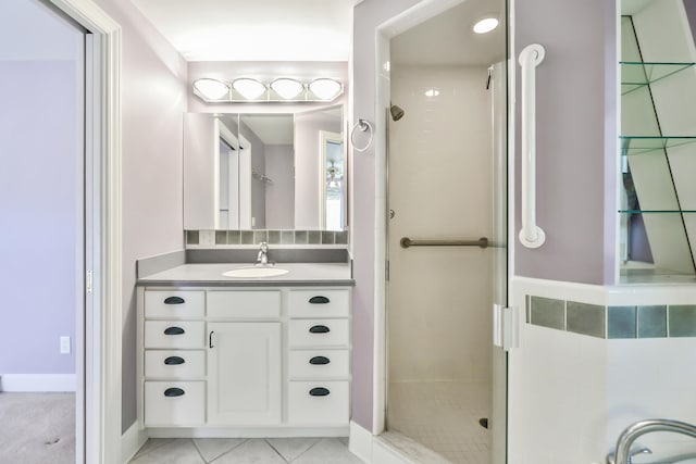 bathroom featuring vanity, walk in shower, and tile patterned flooring