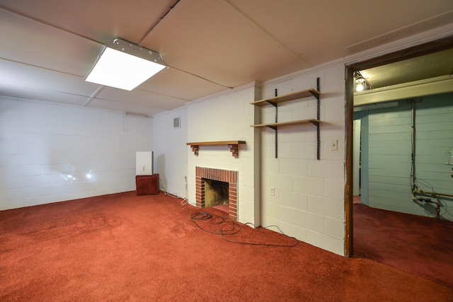 basement with carpet flooring and a brick fireplace