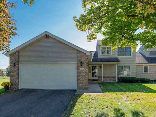 view of front of property with a front yard and a garage