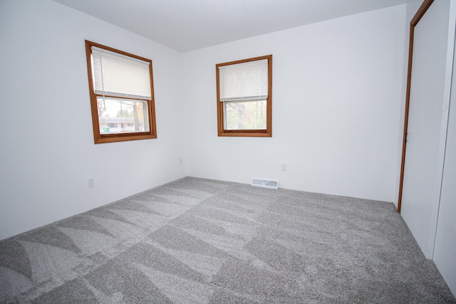 carpeted spare room with visible vents