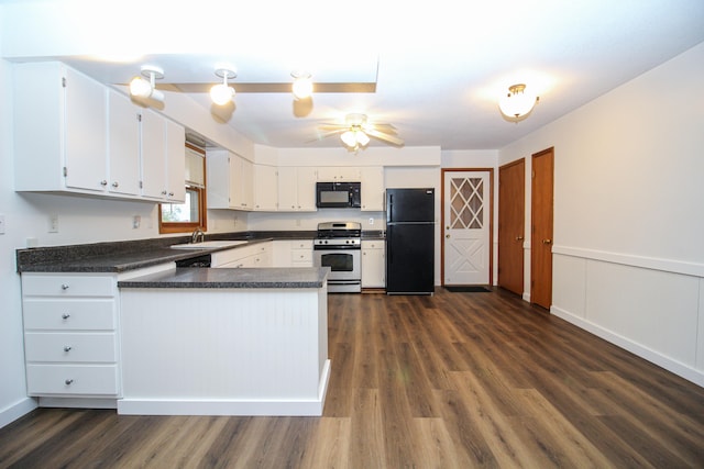 kitchen featuring a sink, white cabinets, wainscoting, black appliances, and dark countertops