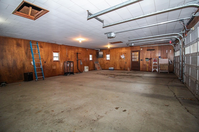 garage featuring wood walls and a garage door opener