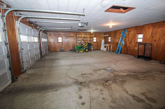 garage featuring wood walls and a garage door opener