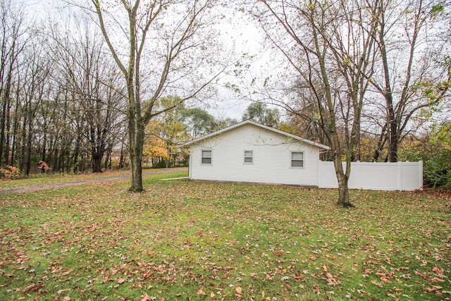 view of side of property with a yard and fence