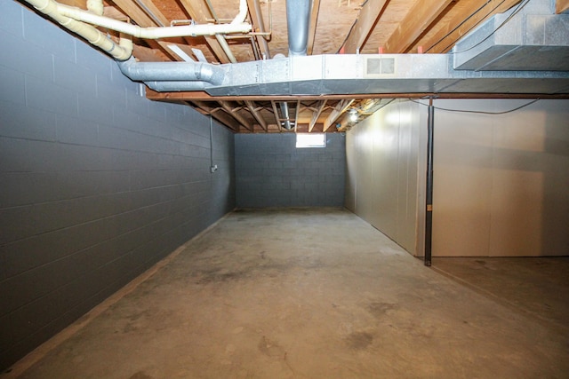 basement with concrete block wall and visible vents