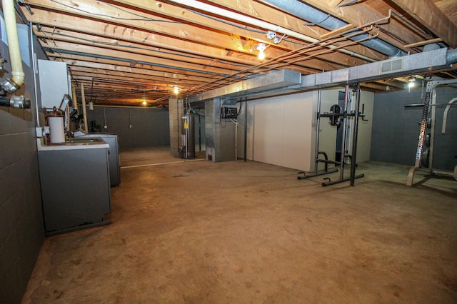 unfinished below grade area with washer / clothes dryer and gas water heater