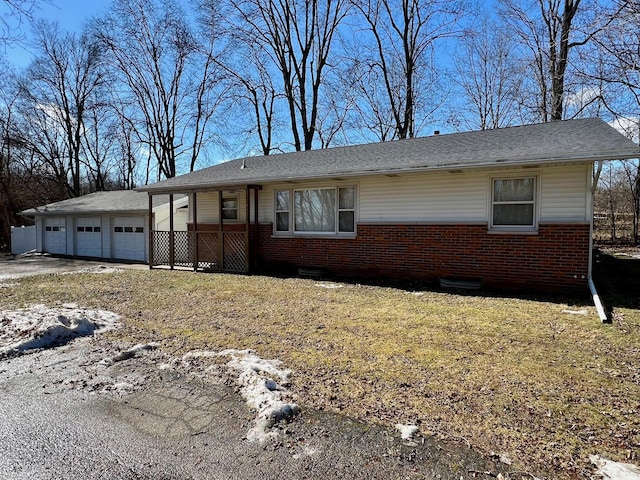 view of front of house with concrete driveway, brick siding, and an attached garage