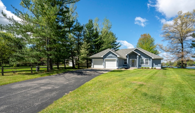 ranch-style house with a garage and a front lawn