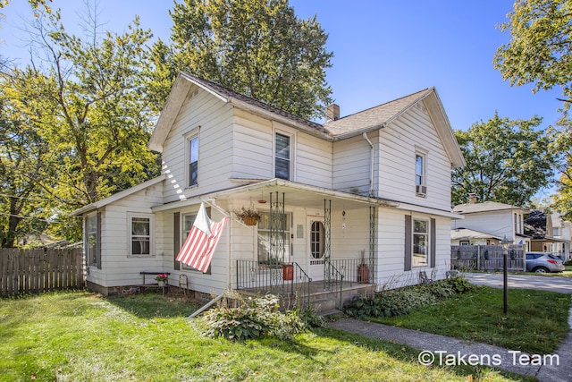 view of front of house with a porch and a front yard