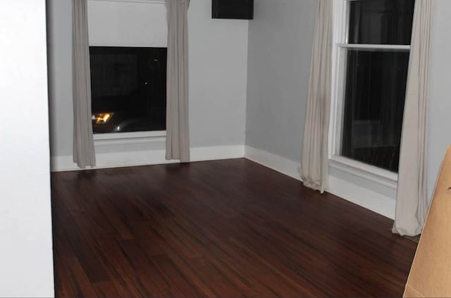 spare room with dark wood-type flooring