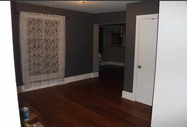 spare room with dark hardwood / wood-style flooring