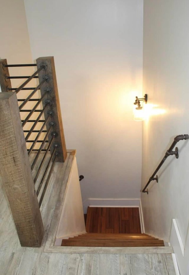 stairs featuring hardwood / wood-style floors