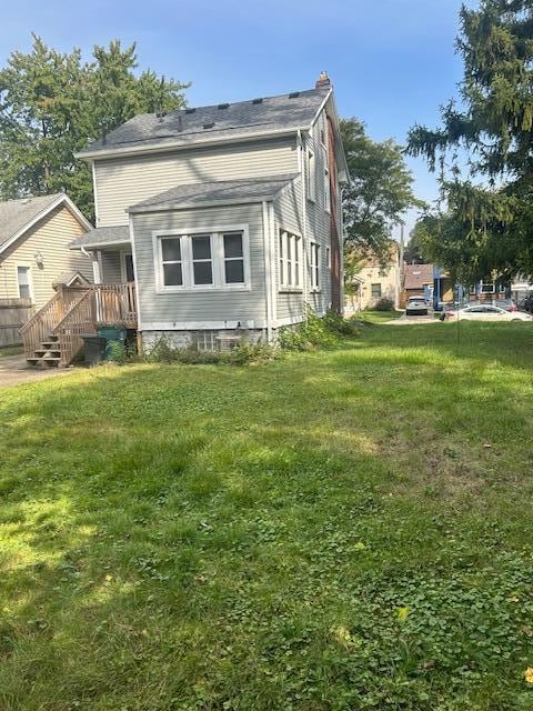 rear view of property with a yard