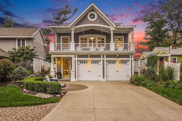 view of front of property featuring a balcony, a garage, and a porch