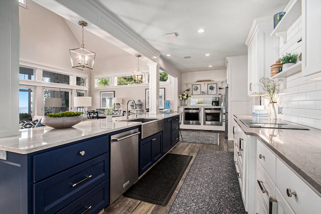 kitchen featuring blue cabinets, white cabinets, sink, dark wood-type flooring, and stainless steel appliances