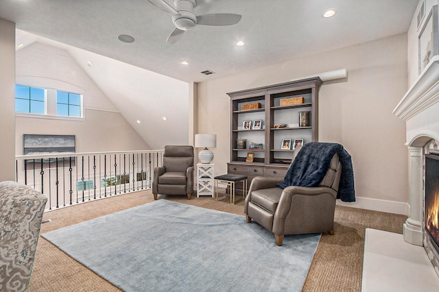 sitting room featuring carpet, vaulted ceiling, and ceiling fan