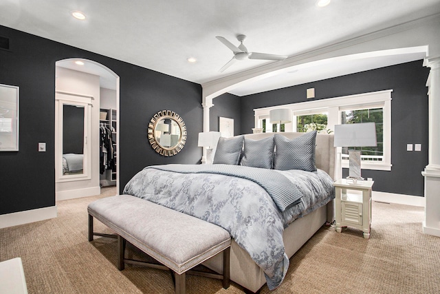 bedroom featuring ceiling fan, light colored carpet, a closet, and a spacious closet