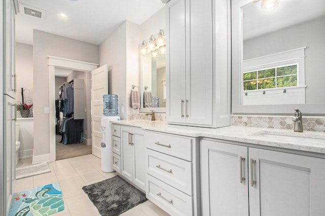 bathroom with vanity, tile patterned flooring, and toilet