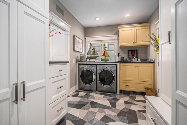 laundry area featuring cabinets and washing machine and dryer