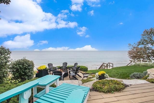 view of patio / terrace featuring a water view and an outdoor fire pit