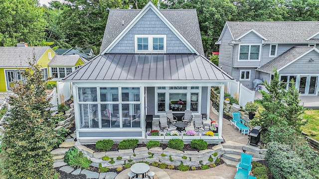 rear view of house with a patio and a sunroom