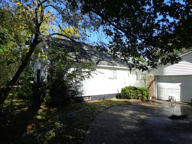 view of side of home with a garage