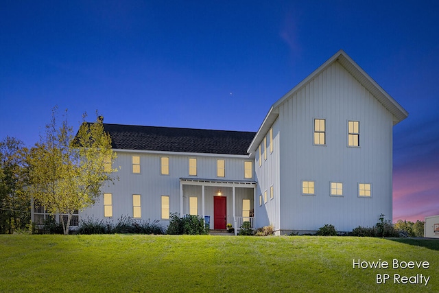 modern farmhouse style home with a lawn