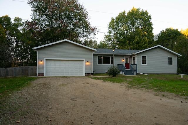 ranch-style house with a garage and a front lawn