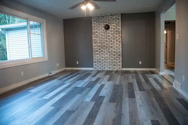 empty room with ceiling fan and dark hardwood / wood-style flooring