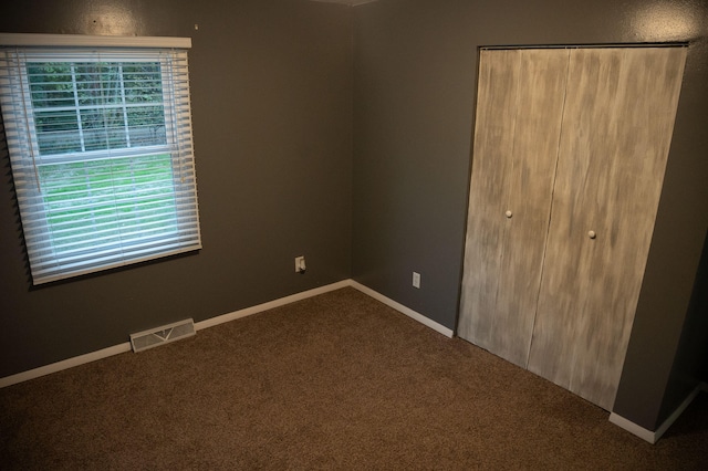 unfurnished bedroom with a closet and carpet