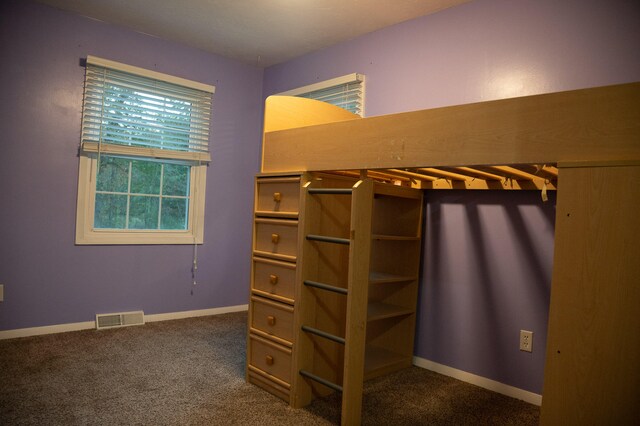 unfurnished bedroom featuring dark colored carpet