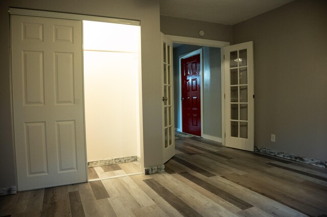 interior space with french doors and wood-type flooring