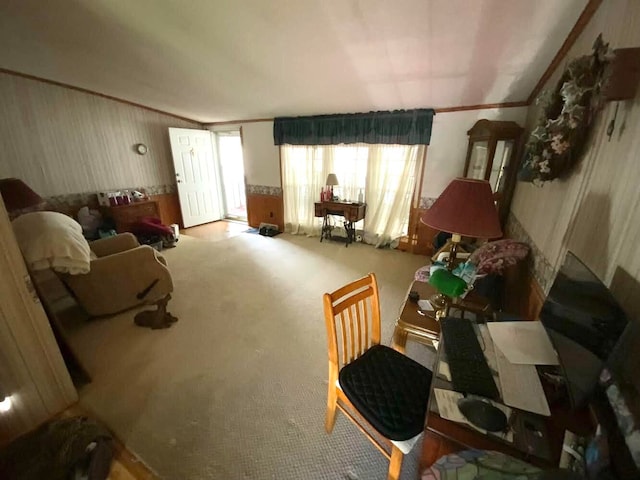 living area with crown molding and carpet